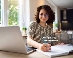 Hình ảnh về Person studying while working on laptop