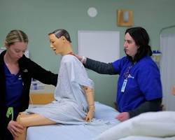 Hình ảnh về Nursing students practicing in a modern lab with mannequins